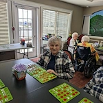 Charter Senior Living of Bay City smiling resident during activity - Bingo