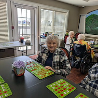 Charter Senior Living of Bay City smiling resident during activity - Bingo