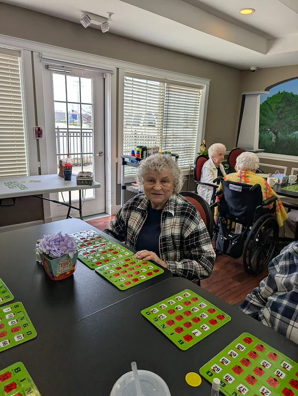 Charter Senior Living of Bay City smiling resident during activity - Bingo