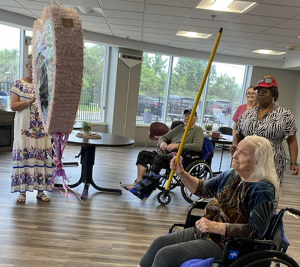 Long House senior living community offering independent living and respite care in Erlanger, KY, residents enjoying an activity with a pinata