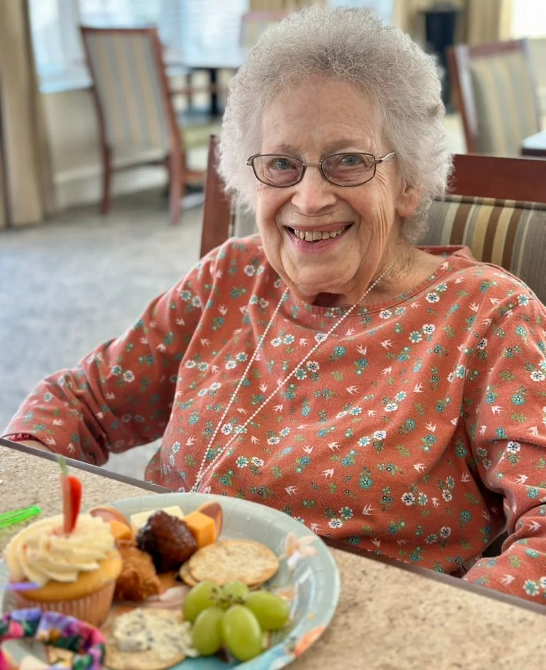 Charter Memory Care of Moline resident smiles with treats