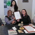 American House Dearborn Heights, senior living community offering independent living and respite care in Dearborn Heights, MI, resident smiling and receiving recognition