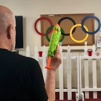 Meadowlark Estates Gracious Retirement Living Hawthorn Senior Independent Living in Lawrence, Kansas residents playing a competitive water gun game