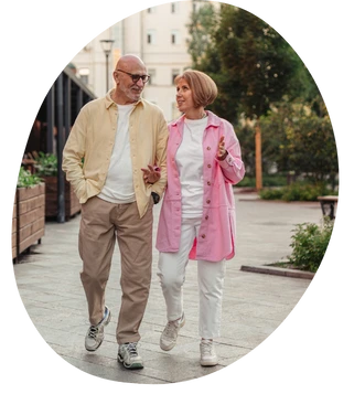 two seniors walking outside