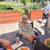 Grande Ronde Retirement Residence senior living community offering independent living, assisted living, and respite care in La Grande, OR, resident relaxing outside and enjoying a refreshment