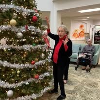 The Highlands Gracious Retirement Living Hawthorn Senior Independent Living in Westborough, Massachusetts resident decorating a Christmas tree
