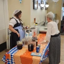 Wenatchee Senior Living by Cogir senior living community offering independent living, assisted living, and respite care in Wenatchee, WA, resident at community German beer party