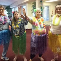 Oak Park Retirement Hawthorn Senior Independent Living in Salisbury, North Carolina residents at a Hawaiian themed party