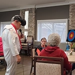 American House Westland Venoy senior living community offering independent living, assisted living, and respite care in Westland, MI, residents enjoying a performance from an Elvis Presley impersonator