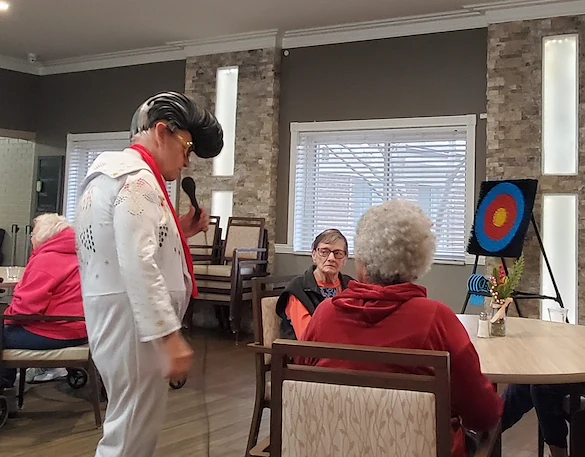 American House Westland Venoy senior living community offering independent living, assisted living, and respite care in Westland, MI, residents enjoying a performance from an Elvis Presley impersonator