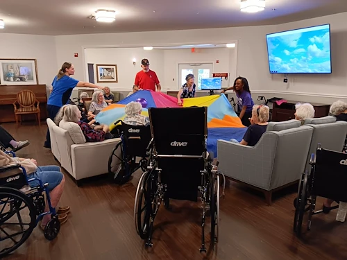 Charter Senior Living of Gainesville, Florida, residents staying active during an engaging parachute activity