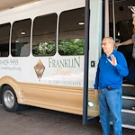 Franklin Park Boerne resident standing in front of the transportation bus