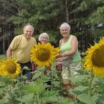 Stoneridge Gracious Retirement Living Hawthorn Senior Independent Living in Cary, North Carolina residents in a sunflower field