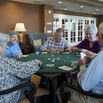 Allegro Hyde Park, senior living community offering independent living, assisted living, and respite care in Tampa, FL, residents playing a game together and socializing