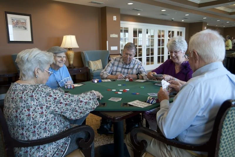 Allegro Hyde Park, senior living community offering independent living, assisted living, and respite care in Tampa, FL, residents playing a game together and socializing