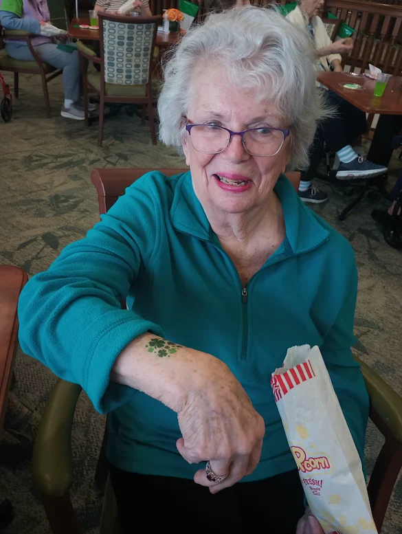 Allisonville Meadows Assisted Living offering assisted living, memory care, and respite care in Fishers, IN, resident enjoying some popcorn