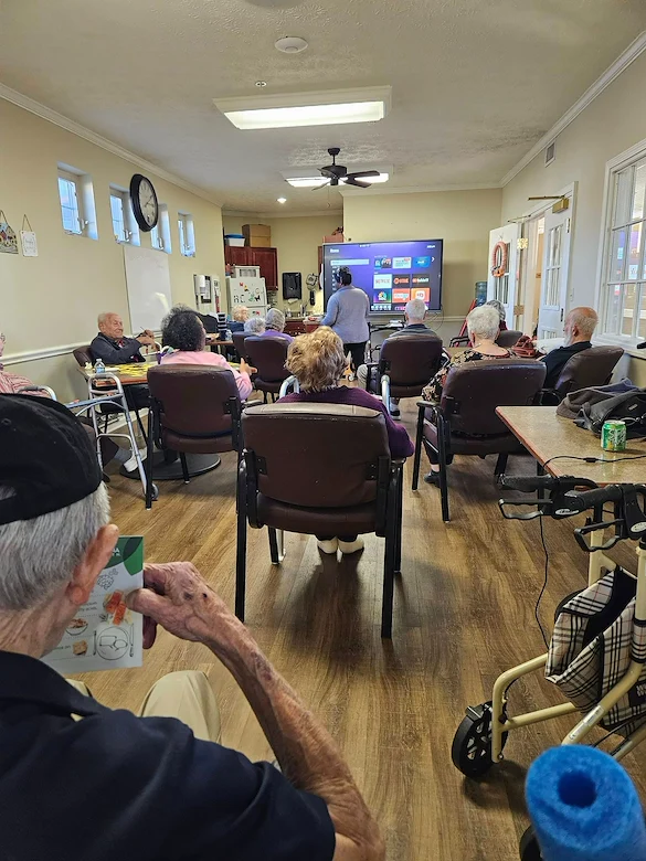 Aberdeen Crossings by New Perspective, senior living community offering assisted living in Highland Heights, OH, residents engaged in a presentation