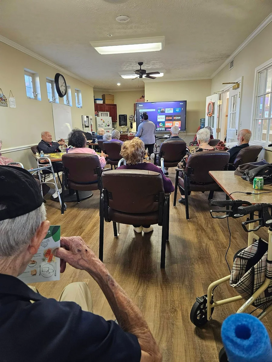 Aberdeen Crossings by New Perspective, senior living community offering assisted living in Highland Heights, OH, residents engaged in a presentation
