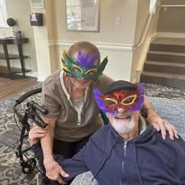 Sonata Coconut Creek seniors wearing mardi gras masks and smiling together