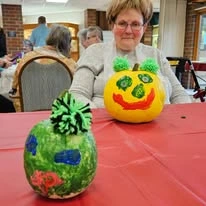 Ascension Living Sacred Heart Village Senior Living in Avilla, Indiana residents painting pumpkins
