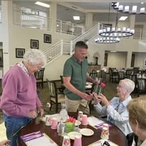 Paloma Landing Retirement Community Hawthorn Senior Independent Living in Albuquerque, New Mexico resident being gifted a flower