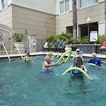 Allegro Hyde Park, senior living community offering independent living, assisted living, and respite care in Tampa, FL, residents staying active and enjoying the pool