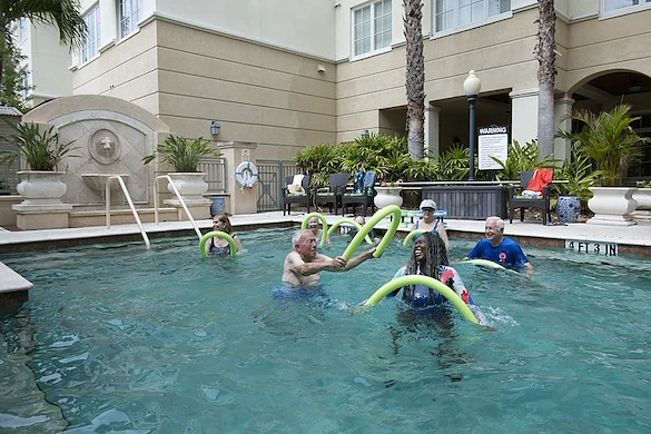 Allegro Hyde Park, senior living community offering independent living, assisted living, and respite care in Tampa, FL, residents staying active and enjoying the pool