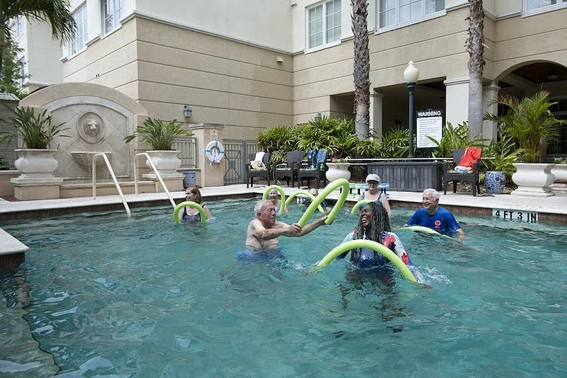 Allegro Hyde Park, senior living community offering independent living, assisted living, and respite care in Tampa, FL, residents staying active and enjoying the pool