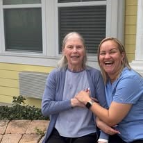 seniors smiling together at Serenades at Longwood