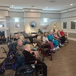 American House Sterling Heights, senior living community offering independent living and respite care in Sterling Heights, MI, residents watching a show