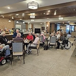 Residents of Broadwell Senior Living at Plymouth participate in their social hour, catching up with old friends and making new ones