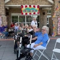 Pioneer Ridge Gracious Retirement Living Hawthorn Senior Independent Living in McKinney, Texas residents at an outdoor party