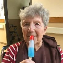 Ascension Living Sacred Heart Village Senior Living in Avilla, Indiana resident eating a popsickle