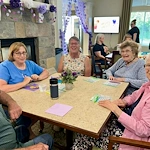 Charter Memory Care of Moline residents have fun playing games and engaging in activities like Bingo