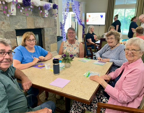 Charter Memory Care of Moline residents have fun playing games and engaging in activities like Bingo