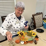 Camellia Gardens Gracious Retirement Living Hawthorn Senior Independent Living in Maynard, Massachusetts resident at make your own fall wreath craft activity