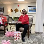 Parkrose Chateau Gracious Retirement Living Hawthorn Senior Independent Living in Portland, Oregon resident opening a Valentine's Day gift