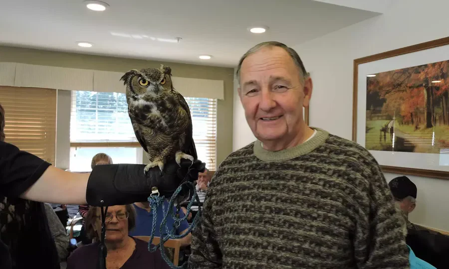 Harvester Place Senior Assisted Living Memory Care in Burr Ridge, IL resident holding an owl