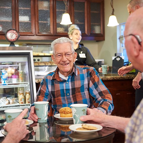 Rosewood Senior Living in Bakersfield, CA, residents socializing and enjoying coffee together at the bistro