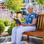 Heatherwood Senior Living resident enjoys reading outside