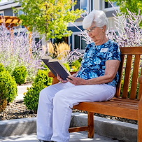 Heatherwood Senior Living resident enjoys reading outside