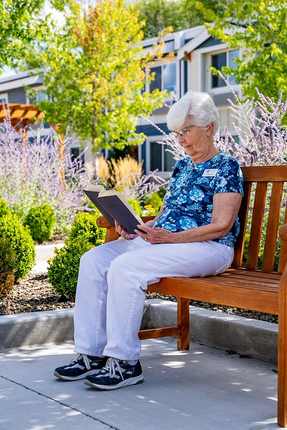 Heatherwood Senior Living resident enjoys reading outside