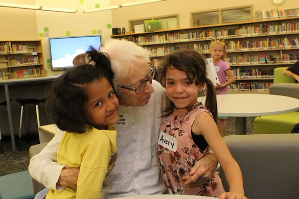 Chelsea Place Memory Care resident hugging children