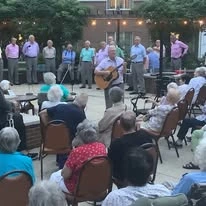 Colonial Gardens Gracious Retirement Living Hawthorn Senior Independent Living in Beverly, Massachusetts residents being musically entertained outdoors