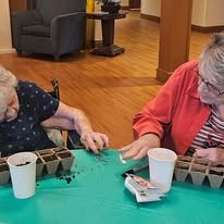 Ascension Living Lakeshore at Siena Memory Care Senior Living in Racine, Wisconsin residents gardening and planting flowers