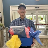 Shads Landing Gracious Retirement Living Hawthorn Senior Independent Living in Charlotte, North Carolina resident holding a box