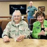 Residents at Kingsley Shores celebrating St. Patrick's Day with shamrock shakes and live music