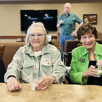 Residents at Kingsley Shores celebrating St. Patrick's Day with shamrock shakes and live music