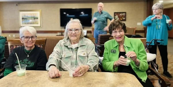 Residents at Kingsley Shores celebrating St. Patrick's Day with shamrock shakes and live music