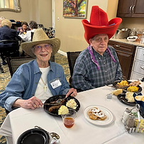 Parkway Place Senior Living residents smiling and enjoying a fun themed meal